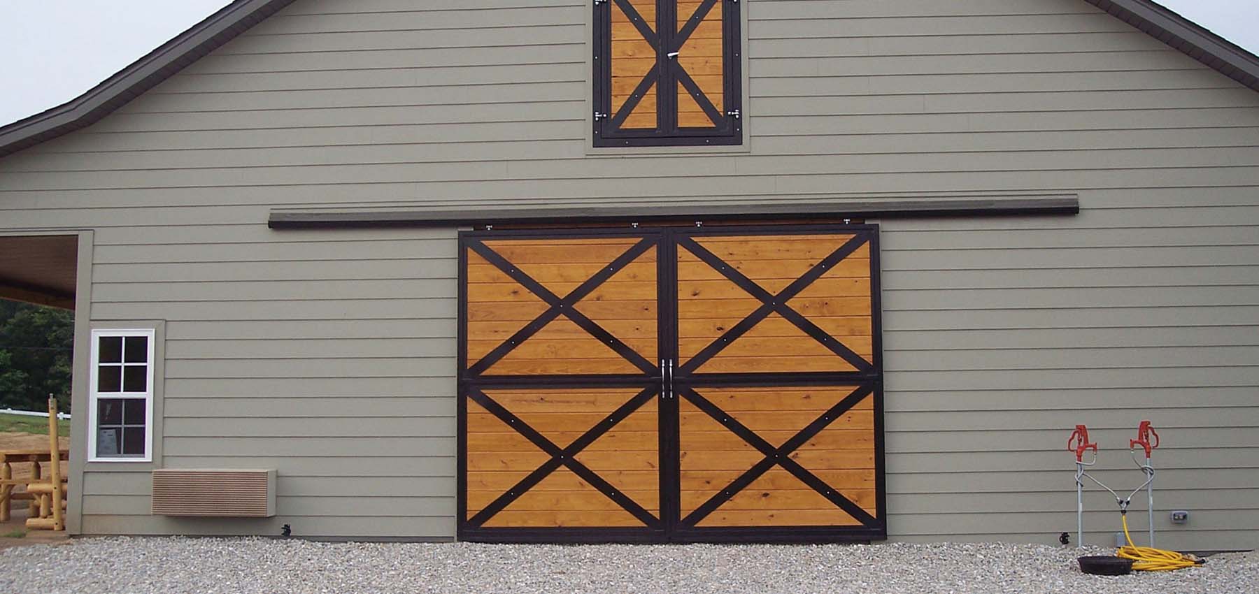 Sliding barn end doors with cross buck and hinged loft door
