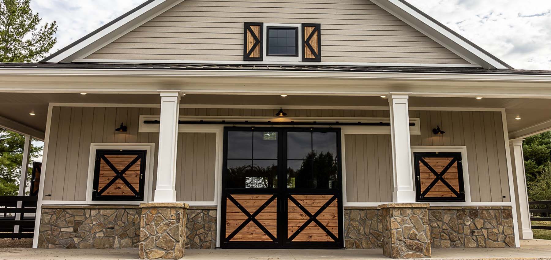Dream barn exterior of barn end doors with framed glass and custom loft shutters