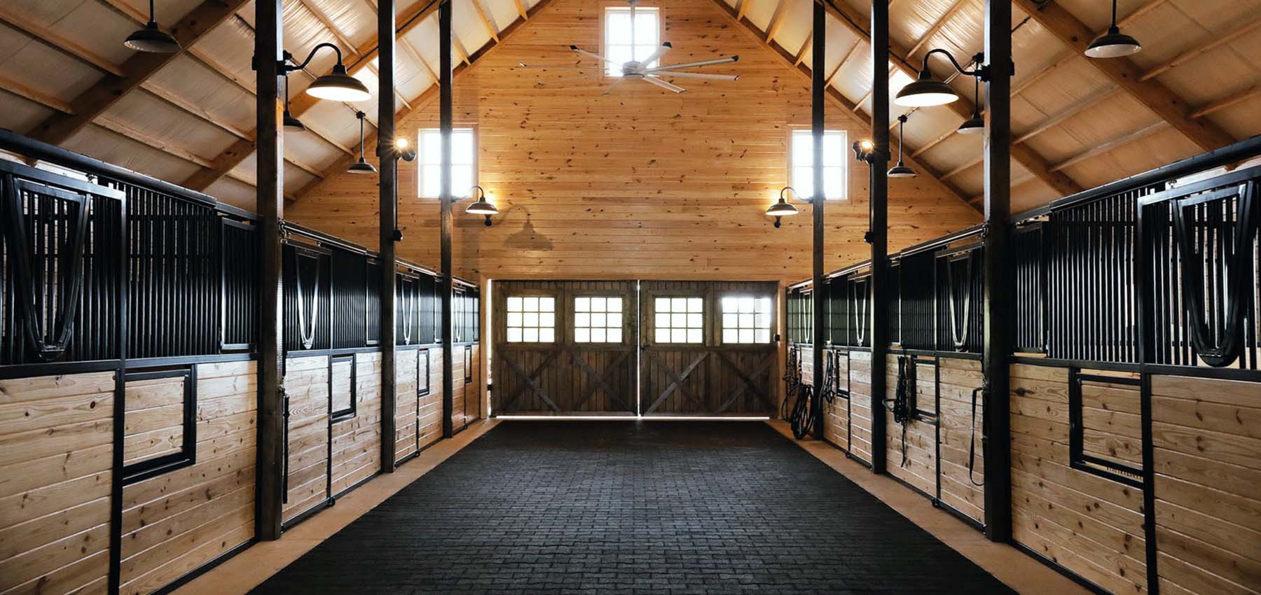 Legend Series sliding-door stall fronts with yoke top doors and Swing-out water buckets