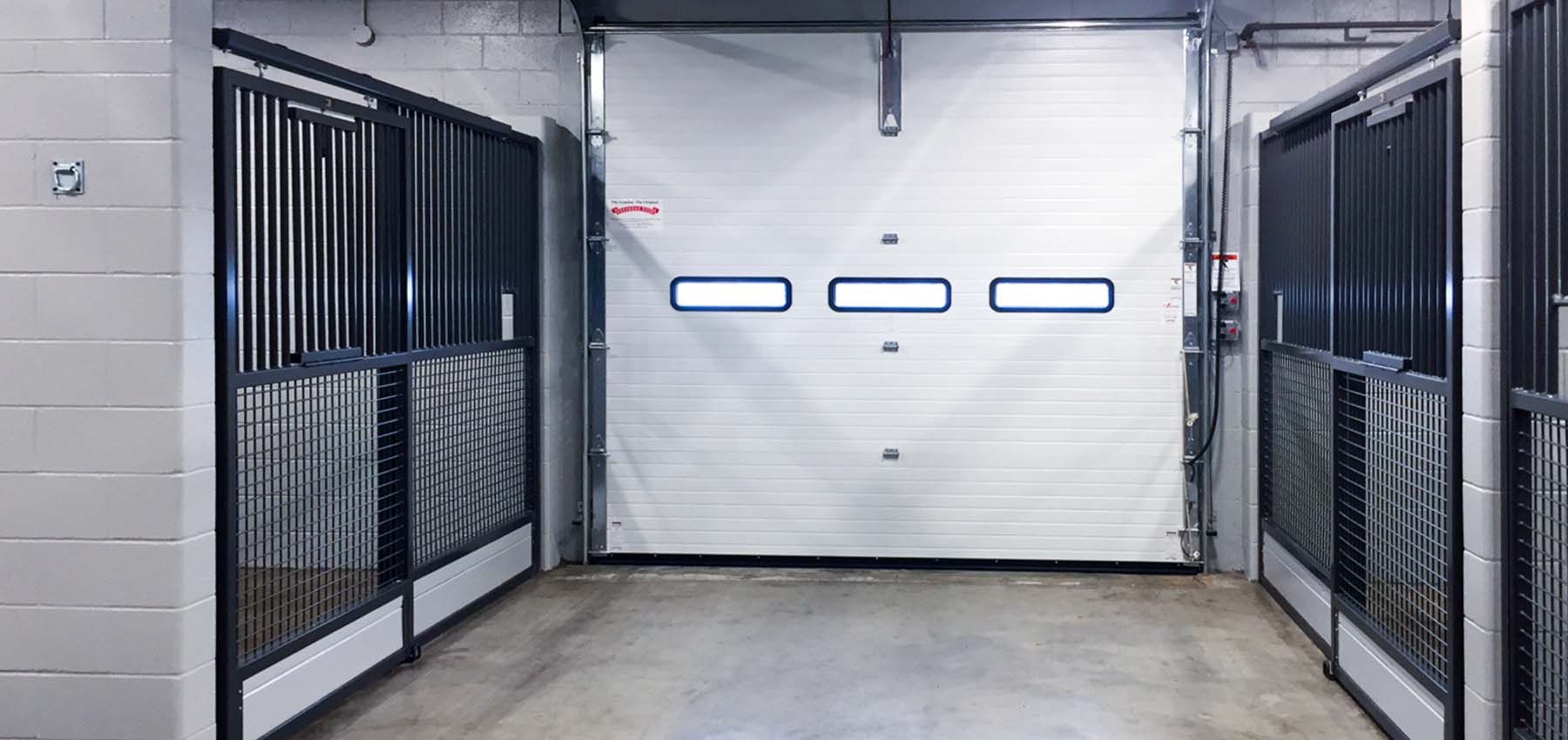 The Rickenbacker Equine Inspection facility features sliding stall fronts with a mesh bottom along with interlocking rubber stall mats.