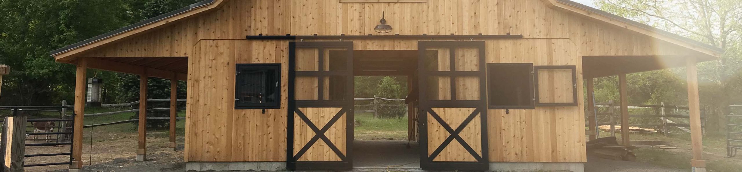 Fontanazza private barn. Close up of barn end doors with framed glass top and wood bottom with cross-buck