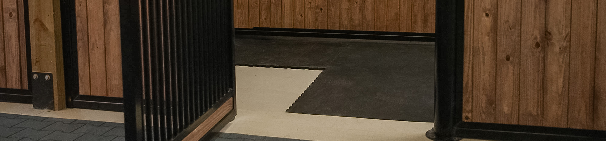 Interlocking horse stall mats in Euro hinged stall