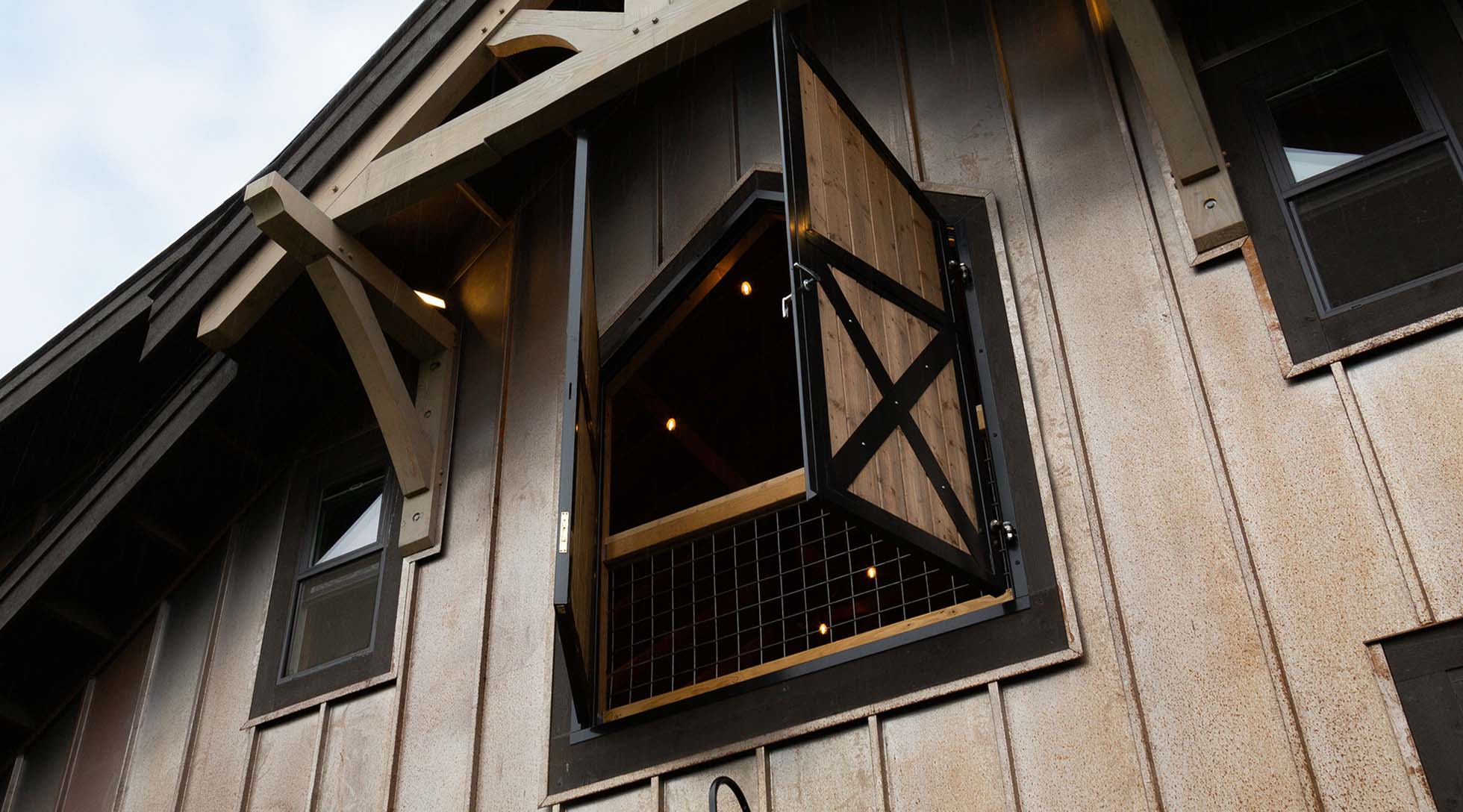 Custom angle-top loft door with cross-buck