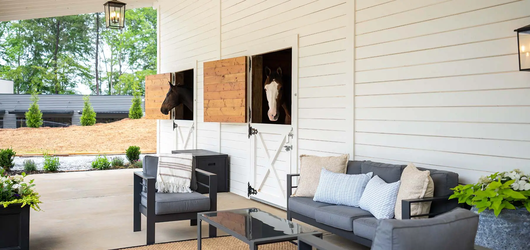 Exterior Dutch doors with horses overlooking patio with outdoor furniture