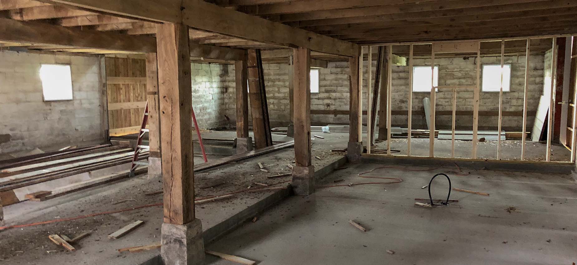 A room with exposed wood beams and window.