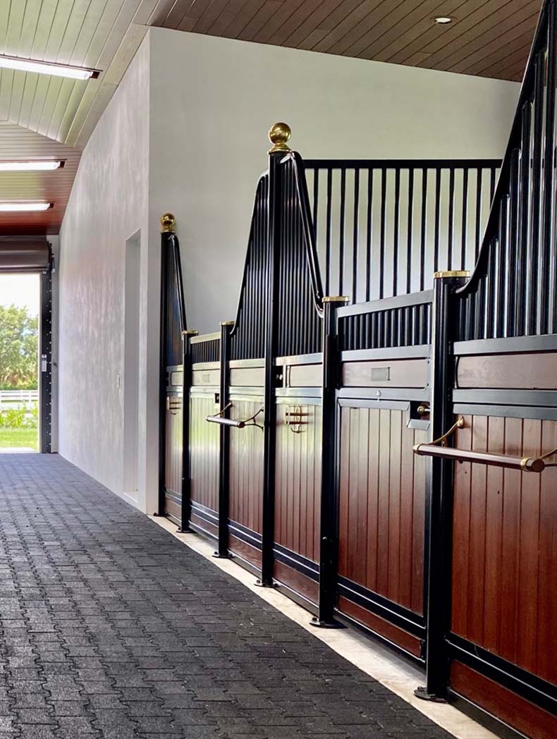 Low euro hinged door stall fronts with gold finials and caps.