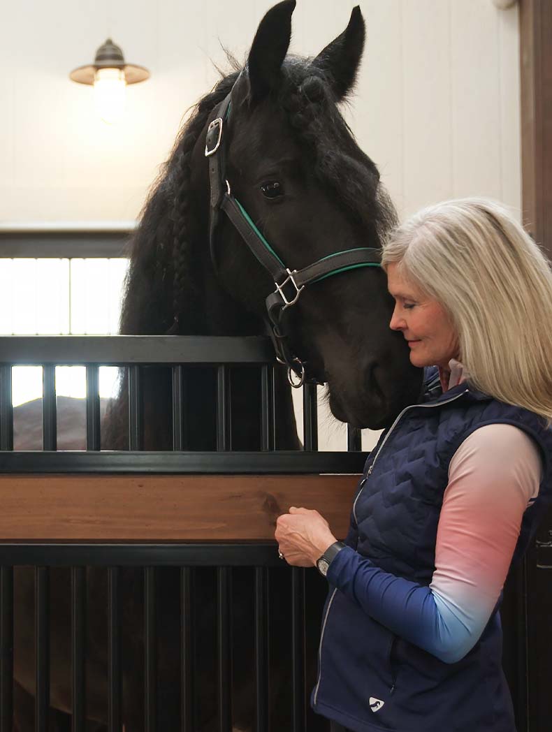 Trainer with horse in custom horse stall